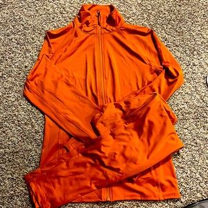Brand new , never worn. Orange stretchy track suit